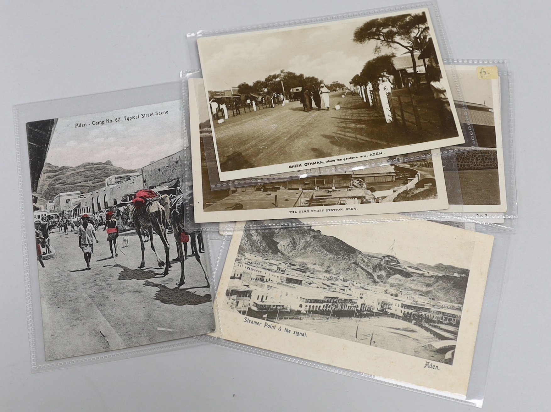 Three enamel 1930s Cresta Run, St. Moritz ice racing toboggan track lapel badges and a Bobsleigh Challenge Cup badge, together with a collection of 46 Aden related postcards from the early 20th century